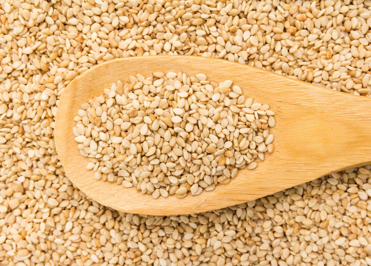 Sesame seeds on a wooden spoon